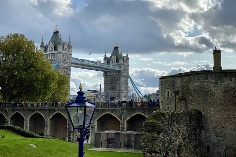 Tower Bridge seen from the Tower of London grounds with a Victorian lamp post in the foreground