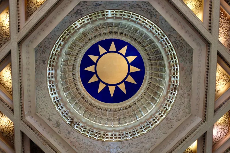 Ornate octagonal ceiling with the Kuomintang sun emblem in blue and gold inside the memorial hall